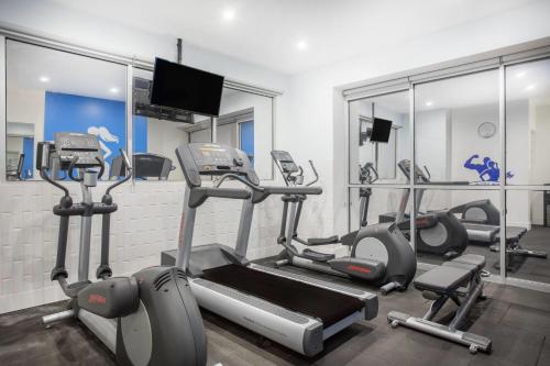 a gym with several tread machines in a room at TRYP by Wyndham Mexico City World Trade Center Area in Mexico City