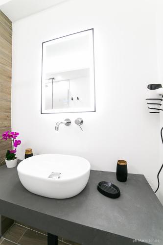 a bathroom with a large white sink on a counter at Casa Sollai in Monserrato