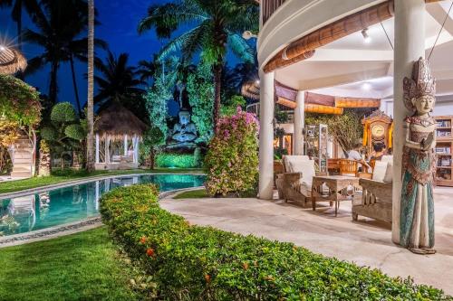 an exterior view of a villa with a swimming pool at The Village of Angels in Manggis