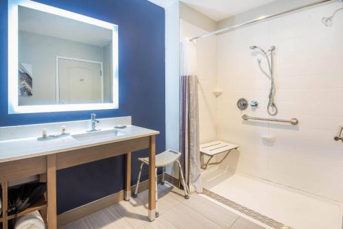 a bathroom with a sink and a shower at La Quinta by Wyndham Buffalo Amherst in Amherst