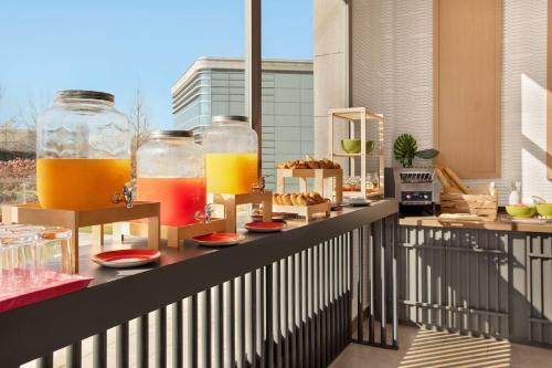 a table with two glasses of orange juice on a balcony at Ramada by Wyndham Madrid Getafe in Getafe