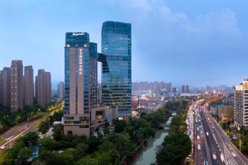 a city with two tall buildings and a river at Kempinski Hotel Fuzhou in Fuzhou