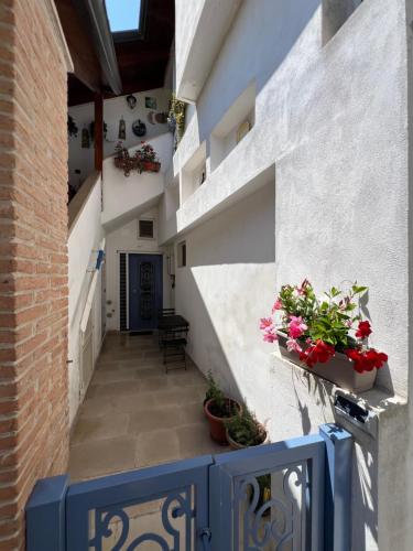 a hallway of a house with flowers on the stairs at Guest House Signature in Bacoli