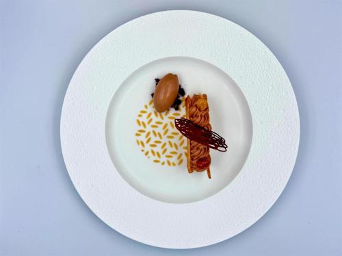a white plate with food on a table at Grand Hotel des Bains Kempinski in St. Moritz