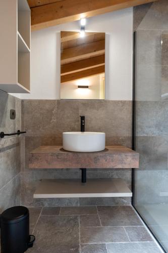 a bathroom with a sink and a mirror at 4 Elementi Relais B&B Lonato del Garda in Lonato del Garda