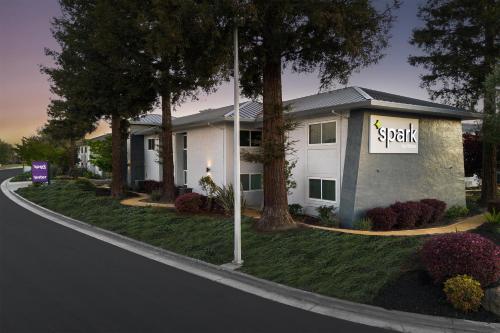 a building with a sign on the side of a street at Spark by Hilton San Jose Airport in San Jose