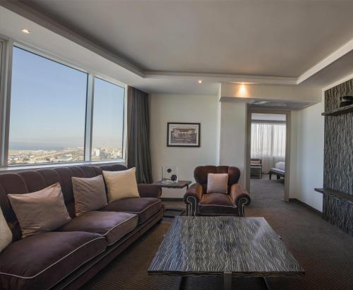 a living room with a couch and a table at Grand Mogador City Center in Casablanca