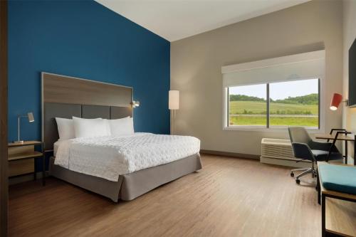 a bedroom with a bed and a desk and a window at Tru By Hilton West Bristol Tn in Bristol