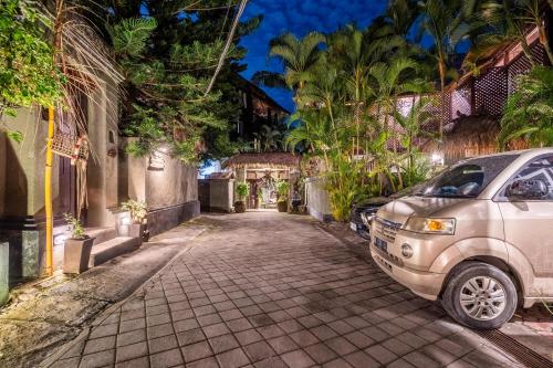 a white van parked on a street at night at The Village of Angels in Manggis