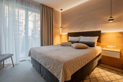 Ένα ή περισσότερα κρεβάτια σε δωμάτιο στο NEA Apartments