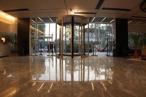 a lobby with a reflection of a glass building at Ramada Encore by Wyndham Chandigarh Zirakpur in Zirakpur