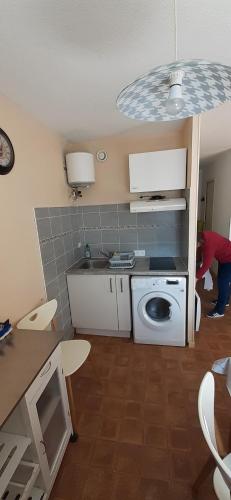 une cuisine avec une machine à laver dans une pièce dans l'établissement P2 35m2 LeGrau du Roi, au Grau-du-Roi