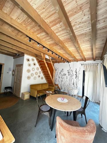 a room with a table and chairs and a staircase at Szumidomki strefa z jacuzzi sauna widok na potok las in Zawoja