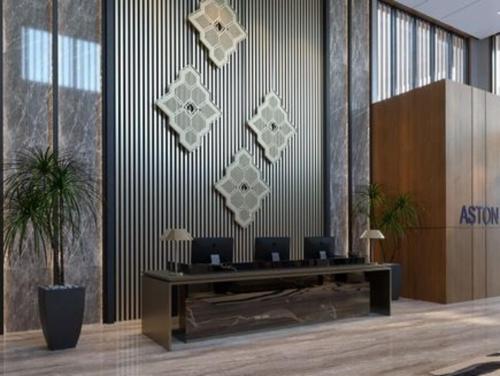 a lobby with a desk with two computers on it at Aston Palu Hotel & Conference Center in Palu
