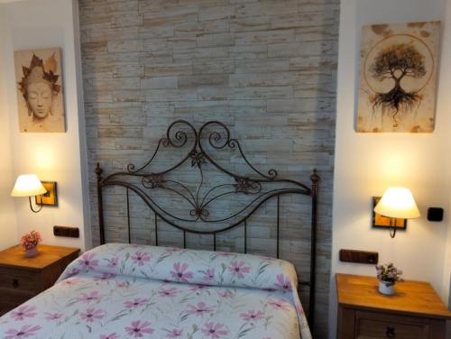 a bedroom with a bed and two night stands at Casa El Albero (Torcal-Caminito del Rey) in La Joya