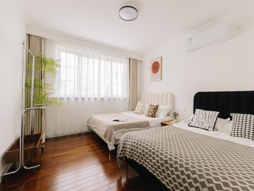 a bedroom with two beds and a couch at Book and Bed-People's Square in Shanghai
