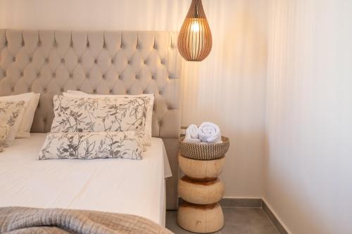 a bedroom with a bed with a tufted headboard at Panorama Seaside in Mastichari