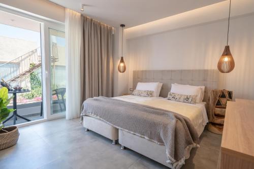 a bedroom with a bed and a large window at Panorama Seaside in Mastichari