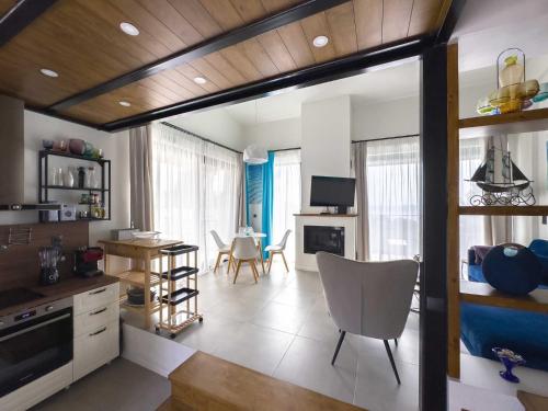 a kitchen and living room with a table and chairs at Damari Luxury Retreat Villas Skiathos in Skiathos Town