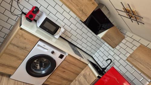 an overhead view of a washing machine in a kitchen at Apartamentos Pino in Benidorm