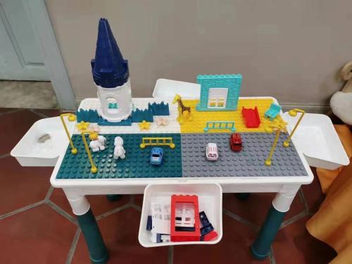 a lego table with a toy house and cars on it at Gulangyu Liuyue Garden Resort Hotel in Xiamen