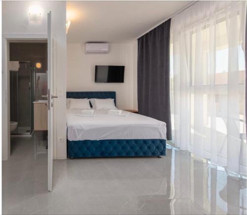 a bedroom with a bed and a large window at Appartements VIR in Vir