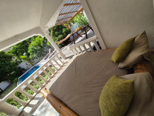 a bedroom with a bed and a balcony at Kaz Memel in Beau Vallon