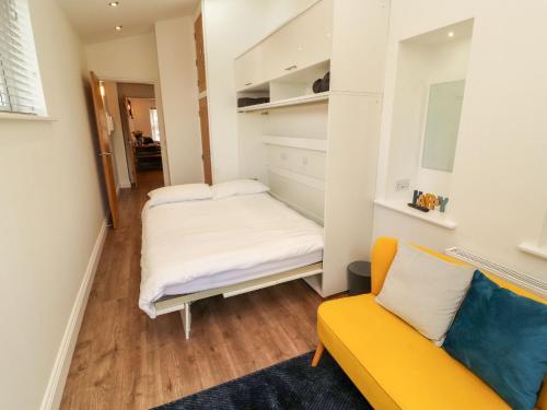 a small room with a bed and a couch at Lakes View Apartment 1 in Carnforth