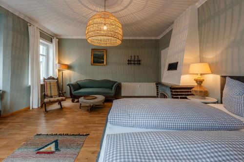 a bedroom with a bed and a living room at Strömbergs Merle in Oberstaufen