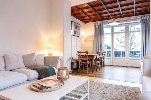 a living room with a couch and a table at Strömbergs Merle in Oberstaufen