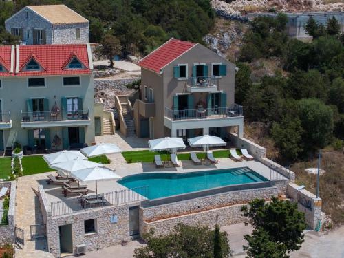 an aerial view of a house with a swimming pool at THISEFS luxury apartments Kefalonia in Antipata