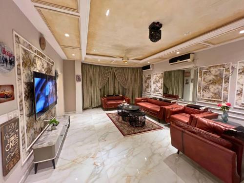 Una sala de estar con sofás y un televisor de pantalla plana. en Luxury family properties in Centaurus, Blue area, F10, F11, Park, en Islamabad