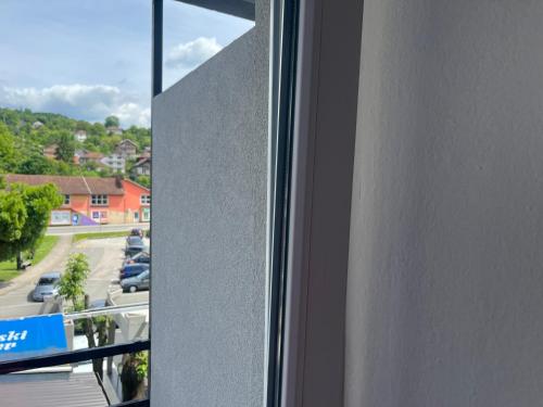 a window with a view of a parking lot at Hotel Bosna in Kladanj