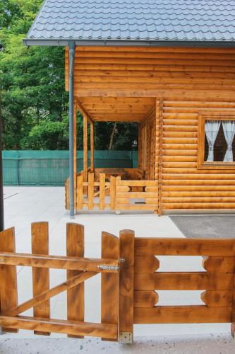 a wooden cabin with a fence in front of it at Hafizove ville na Uni in Illidža