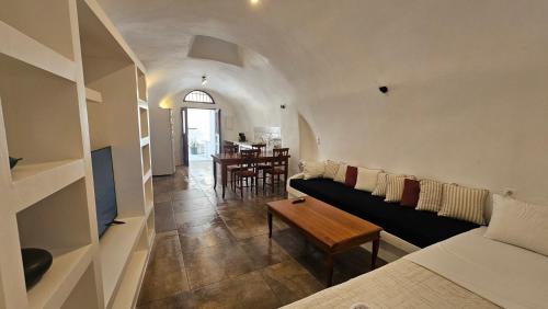 a living room with a couch and a table at Kalitsi Canaves in Vóthon