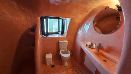 a bathroom with a sink and a toilet and a mirror at Kalitsi Canaves in Vóthon
