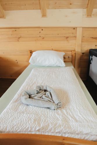 a bed with a towel on top of it at Hafizove ville na Uni in Illidža