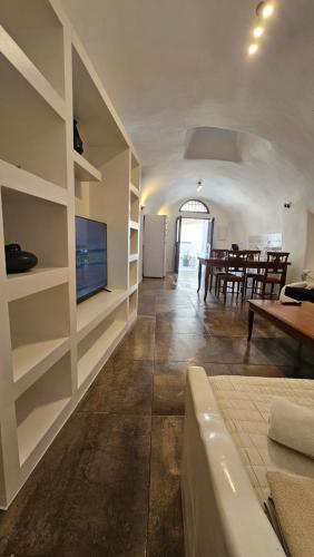 a living room with a television and a dining room at Kalitsi Canaves in Vóthon