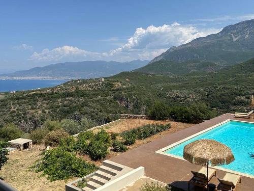 a swimming pool with a view of the mountains at Euphoria Suites in Avia