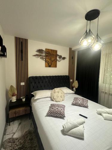 a bedroom with a large bed with two pillows on it at Cozy Escape Apartment in Tecuci