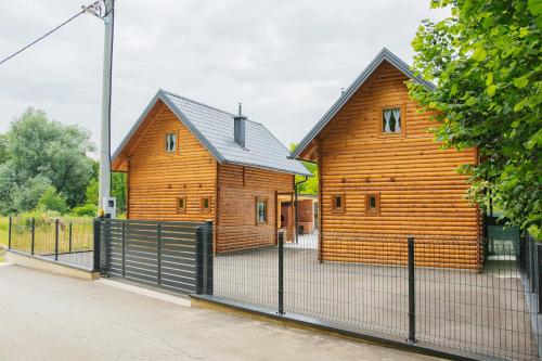 a wooden house with a fence in front of it at Hafizove ville na Uni in Illidža