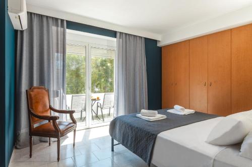 una camera da letto con un letto, una sedia e una finestra di Terra Ventura Villa At The Hill a Trianta