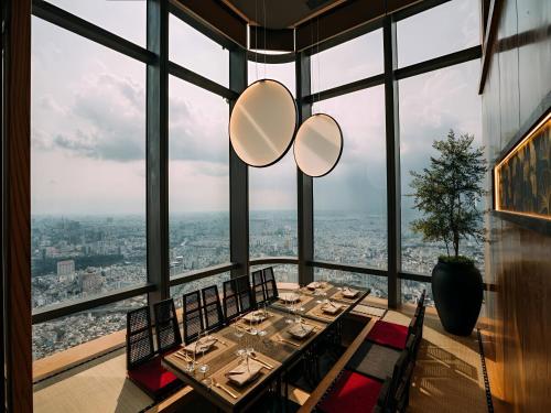 a dining room with a view of the city at The Regal Residence at Vinhomes in Ho Chi Minh City