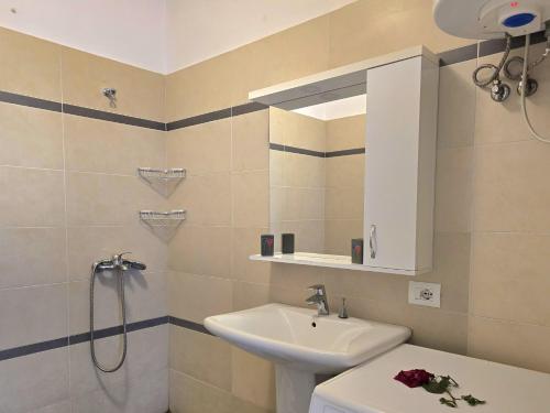 a bathroom with a sink and a toilet and a mirror at Happy Stay In Lalzit Bay 093 in Fushë-Draç