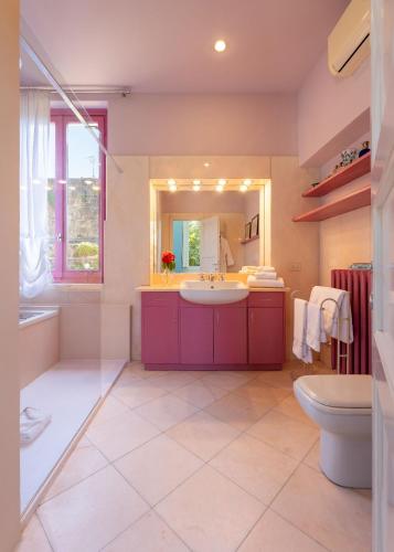 a bathroom with a sink and a toilet and a mirror at Villa Angela in Florence