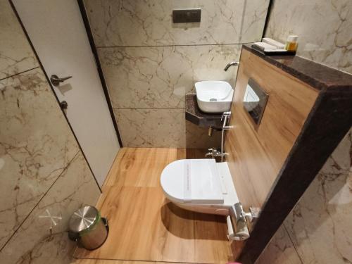 a bathroom with two sinks and a shower at Hotel Ocean Residency Thane West in Thane
