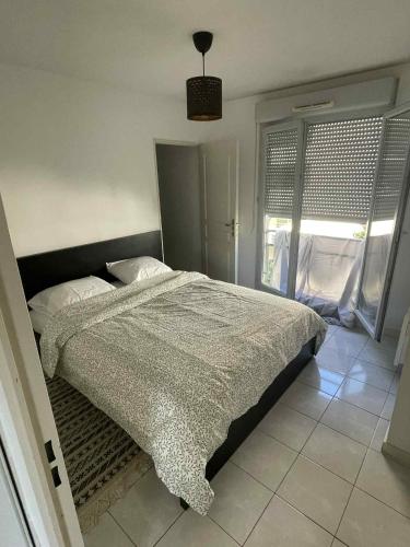 une chambre avec un lit et une fenêtre dans l'établissement Superbe appartement à Lyon8 avec 2 balcons, à Lyon