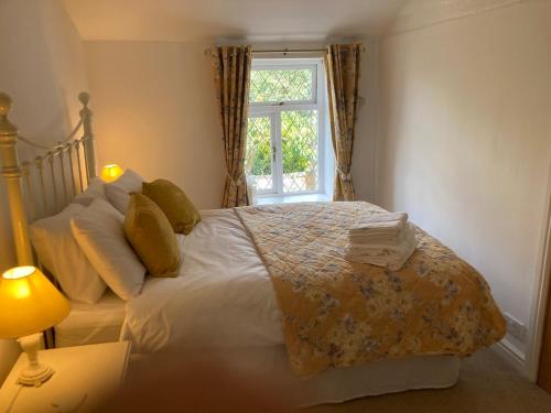 a bedroom with a large bed with a window at The Dotterry in Hill Top