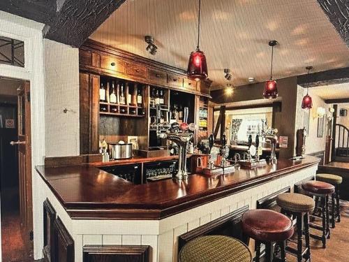a bar with a counter and some stools at The Gillygate Inn in York