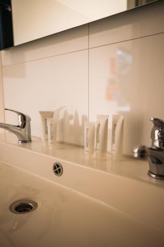 a bathroom counter with a sink and a mirror at Holiday Home Maridu Wellness in Arnhem